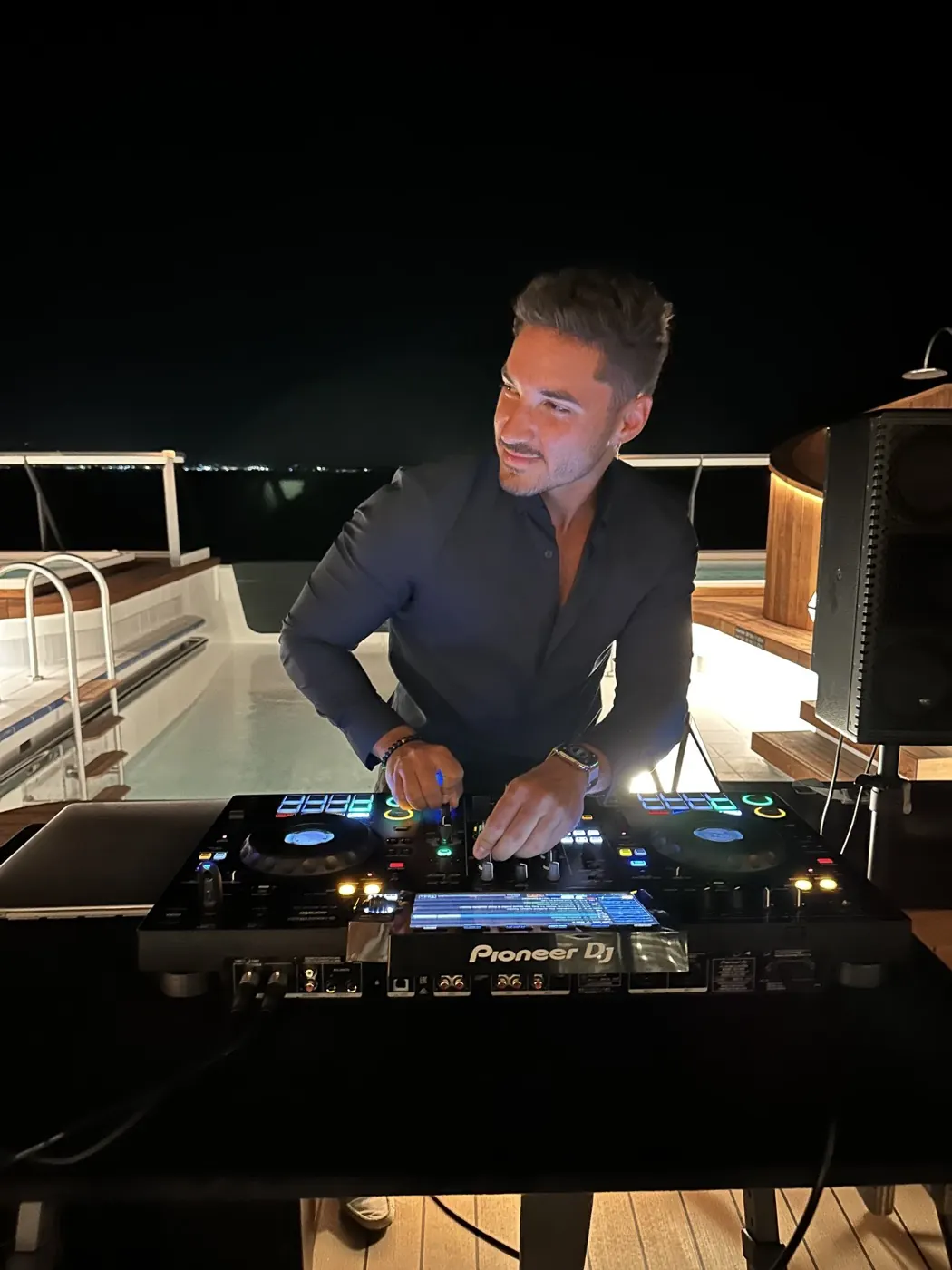 TAVI playing on a rooftop pool deck at night