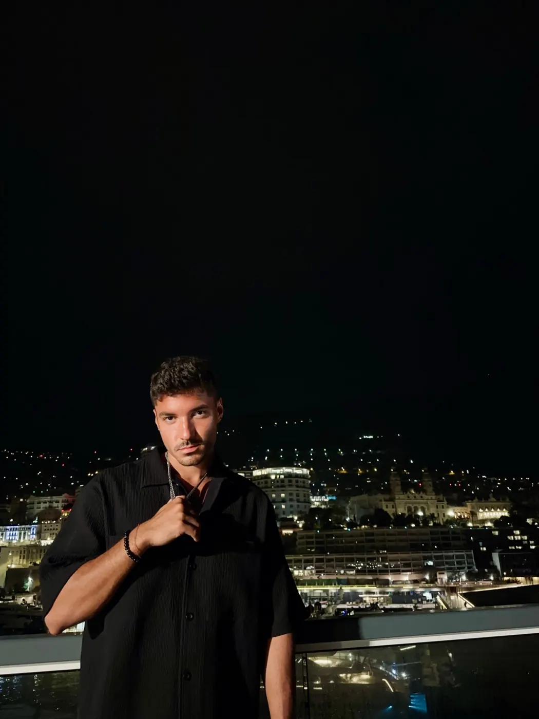 TAVI on a terrace above a harbour at night